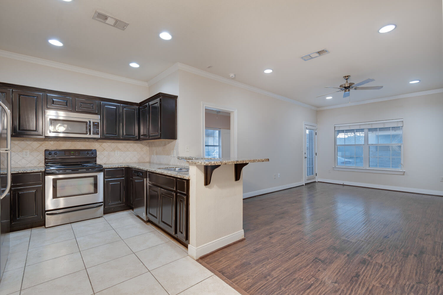 Open view from kitchen to living room's hard wood floors.