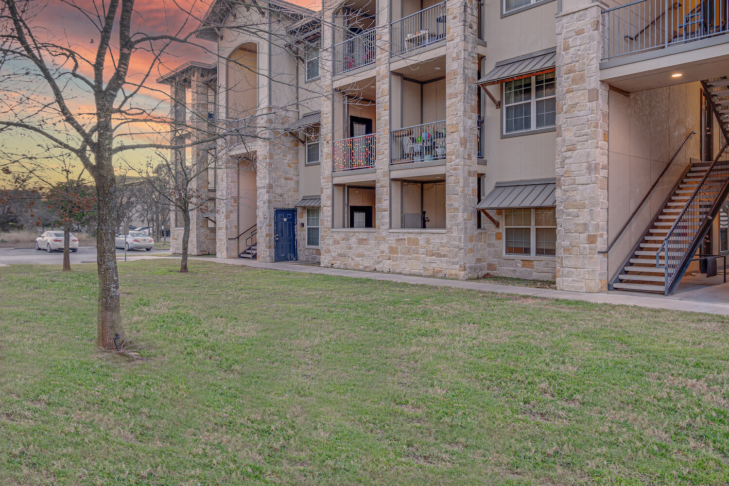 A view of a Logan Ridge building and lawn at sunset.