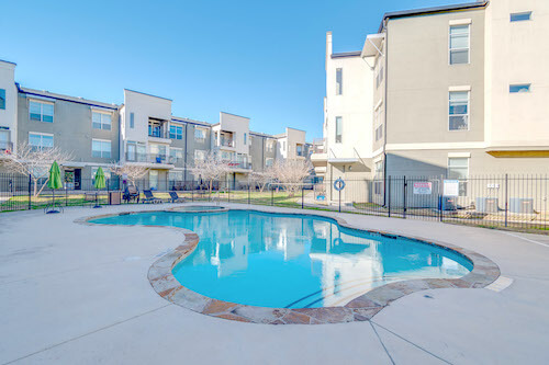 The Logan Ridge sparkling pool surrounded by complex building and community space.